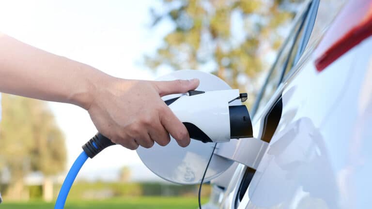 Person plugging EV charger into their car