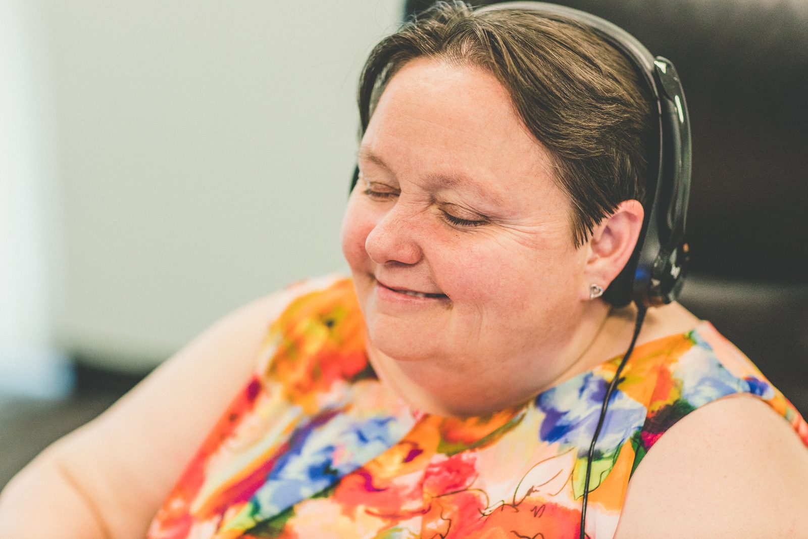 Smiling QualityLogic team member wearing a headset